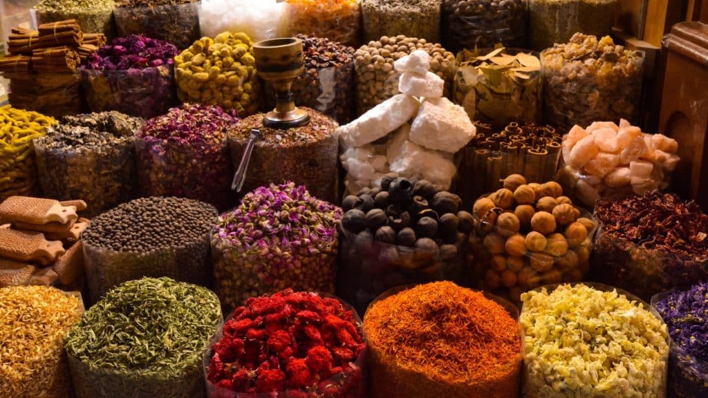 Rows of spices piled high, such as saffron and cumin, are found everywhere in the souks